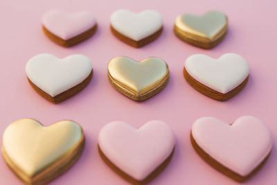 Pink background with sweet gingerbread heart cookies. high quality photo