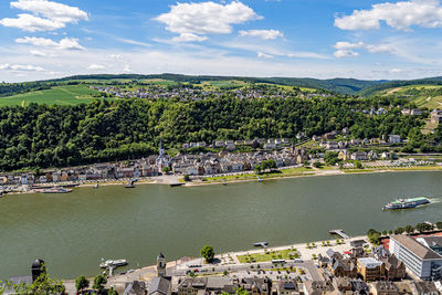 High angle view of townscape by sea against sky