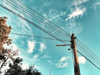 Low angle view of electricity pylon against sky