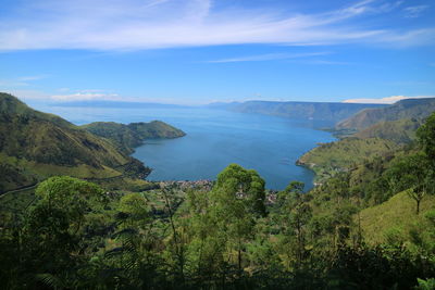 Scenic view of sea and mountains against sky