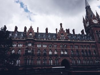 Low angle view of historical building against cloudy sky