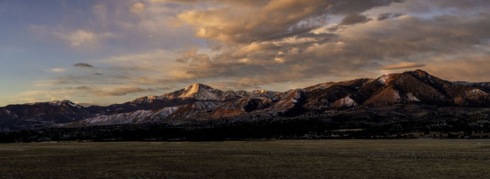 Scenic view of snowcapped mountains against sky during sunset