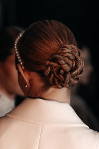 Women's elegant evening hairstyle with hair gathered in a bun. back view