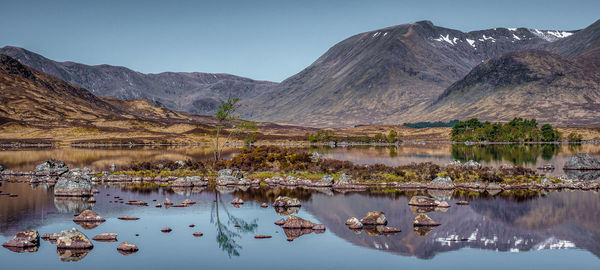 Panoramic view of the reflections of the black mount hills in lochan na h-achlaise on rannoch moor