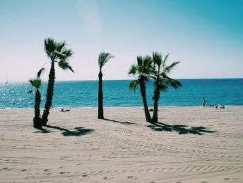 Scenic view of beach against blue sky