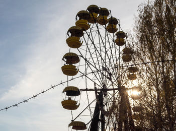 Low angle view of ferris wheel against sky