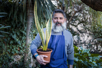 Middle-aged man taking care of his plants in the garden