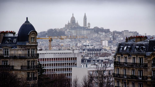Basilique du sacre coeur and cityscape against sky