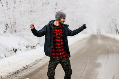 Full length of man standing in snow