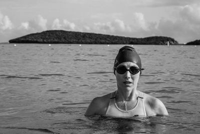 Portrait of triathlete woman swimming at beach.