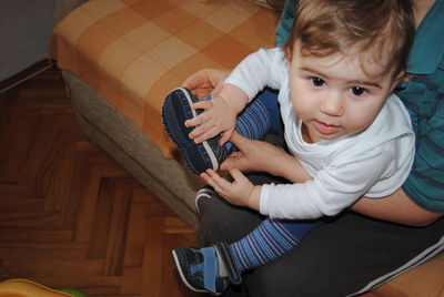 High angle view of boy sitting at home