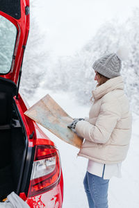 Midsection of woman standing in snow