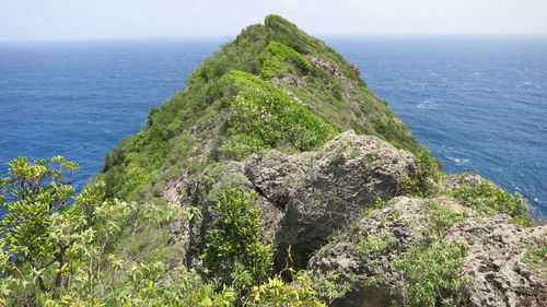 Scenic view of rocks in sea against sky