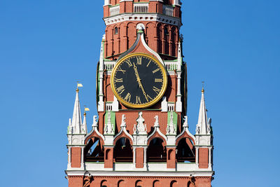 Low angle view of clock tower against clear sky