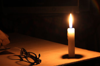 Close-up of lit candles on table