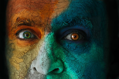 Close-up portrait of mature man with face paint