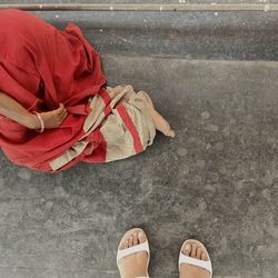 Low section of woman standing on street