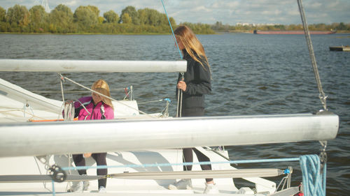 Rear view of people on boat at sea