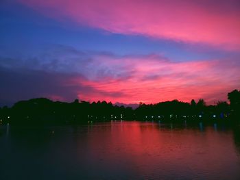 Scenic view of lake against romantic sky at sunset