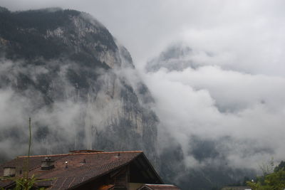 Panoramic view of building and mountains against sky