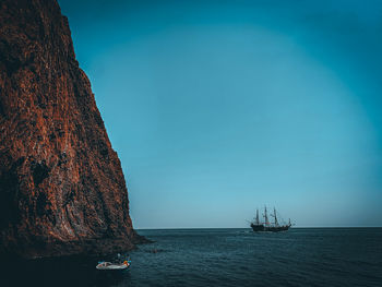 Sailboat sailing on sea against sky