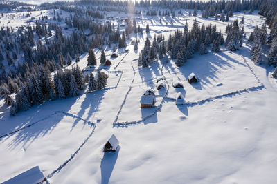 Snow covered remote village, homestead in the mountains. aerial drone view
