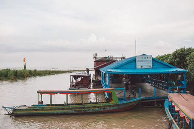 Boat moored in lake against sky