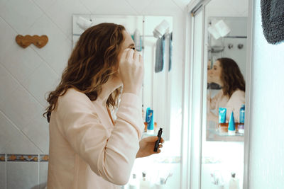 Woman looking at mirror