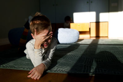 Boy lying on floor