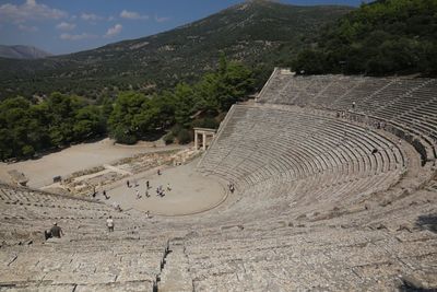 High angle view of old ruins of amphitheater against mountain