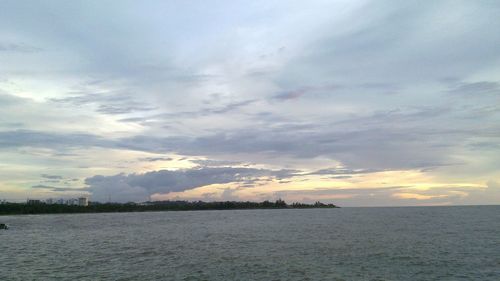 View of calm sea against cloudy sky