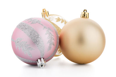 Close-up of christmas decorations against white background