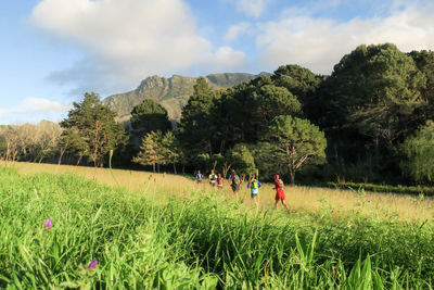 People on field against sky