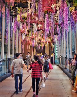 People walking below decorations in modern building