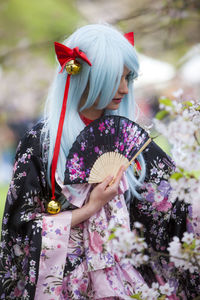 Full length of young woman standing on flower