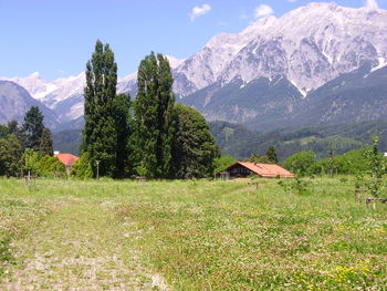 Scenic view of field and mountains against sky