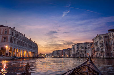 Buildings in city at sunset