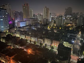 High angle view of illuminated buildings in city at night