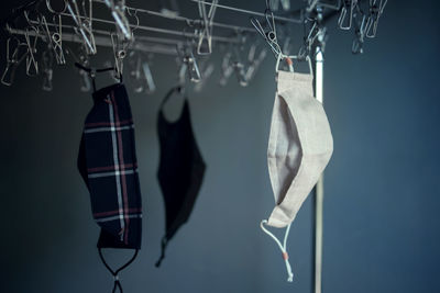 Close-up of clothes hanging on rack against wall