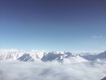 Scenic view of snowcapped mountains against clear blue sky