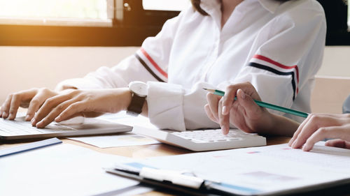 Midsection of woman working on table