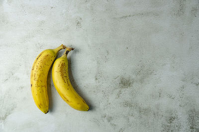 High angle view of yellow fruit against white background