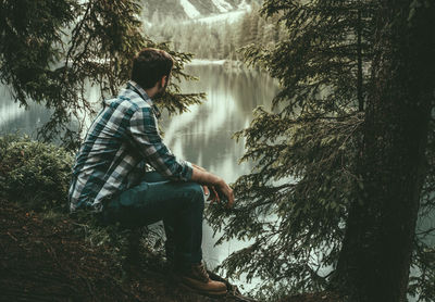 Side view of young man in forest