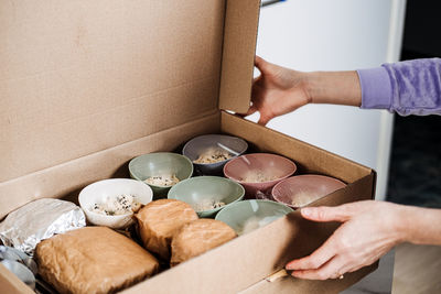 Cropped hand of woman holding food