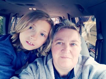 Portrait of smiling woman in car