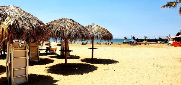 Palm trees on beach against clear sky