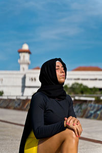 Young woman in hijab exercising outdoors