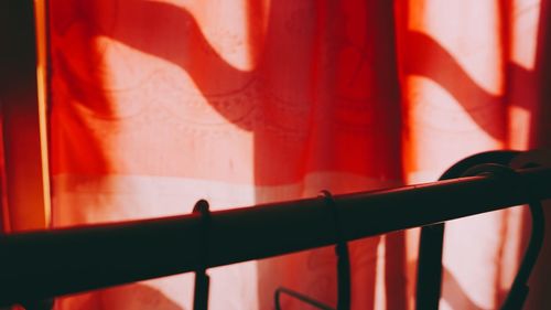 Close-up of railing against window in building