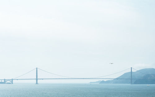 Bridge over sea against sky