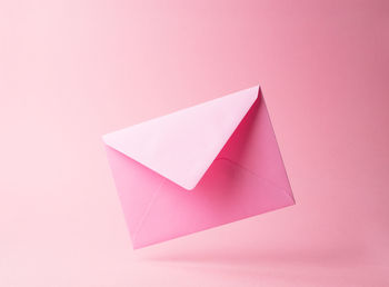 Close-up of paper over pink background